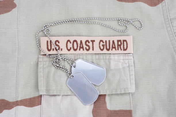 istock US COAST GUARD branch tape with dog tags patch on desert camouflage uniform 1193956145