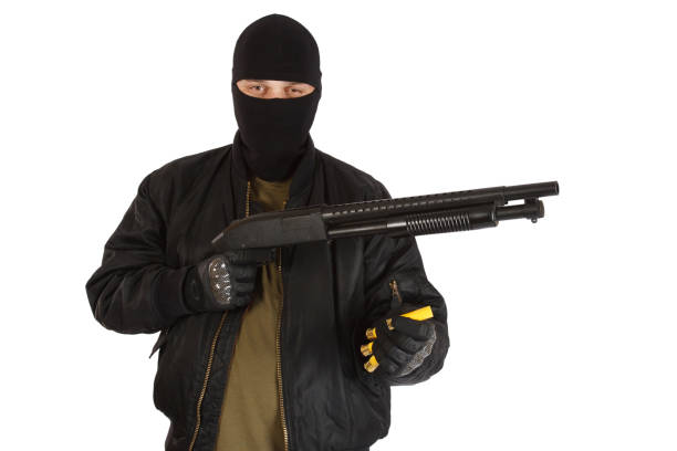 istock robber in black mask with shotgun 1193956207