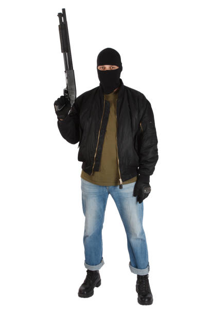 istock robber in black mask with shotgun 1193956349