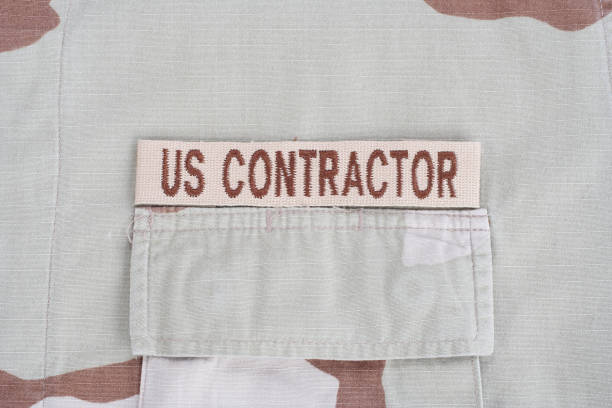 istock US CONTRACTOR branch tape on desert camouflage uniform 1193957133