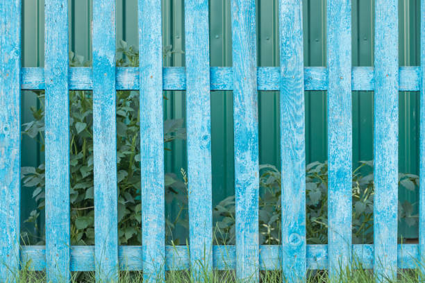 istock Old rustic wooden fence with shabby blue paint 1193958238
