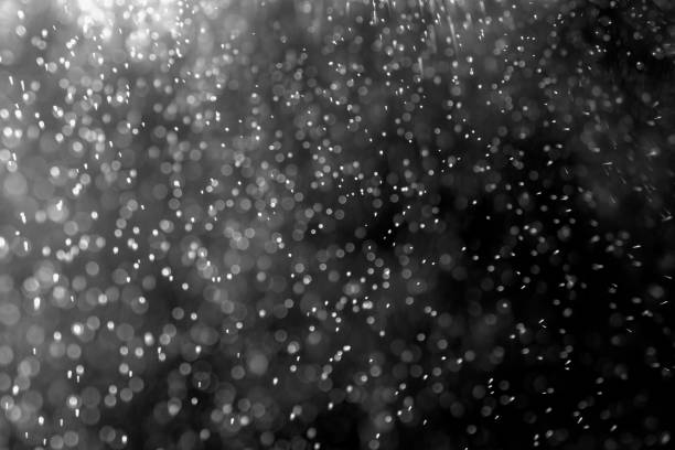 istock abstract splashes of water or snow on a dark background 1193958435