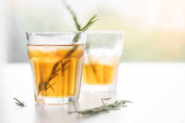 istock alcoholic drink with lemon and rosemary on a white background 1193958804