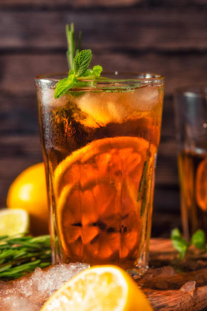 istock Iced tea with lemon and ice on a wooden background 1193959575