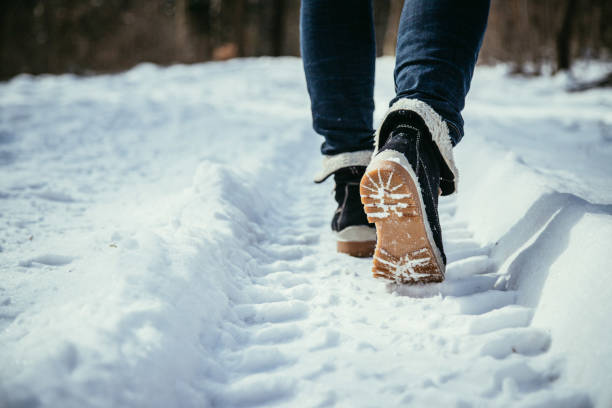 istock Girl is walking on snow, wintertime, cut out 1193959596
