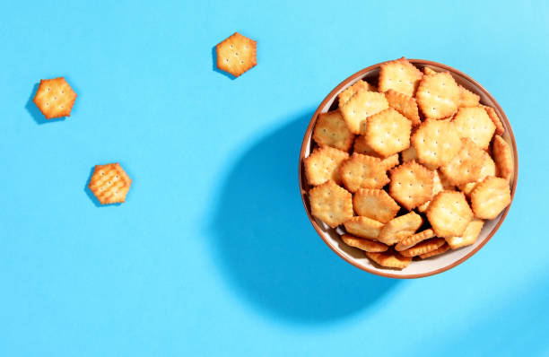 istock crackers in bowl on blue background top view 1193960432