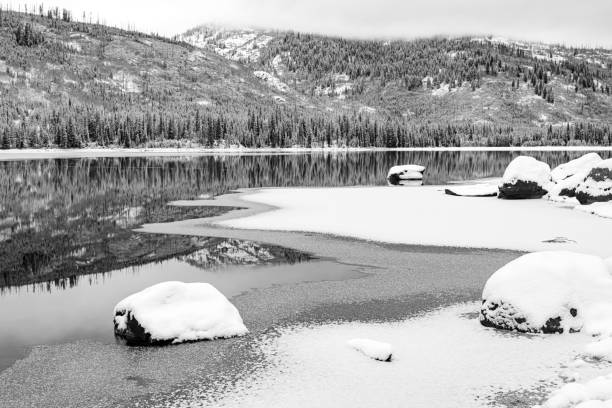 istock High mountain wilderness winter lake with forest reflection 1193962829