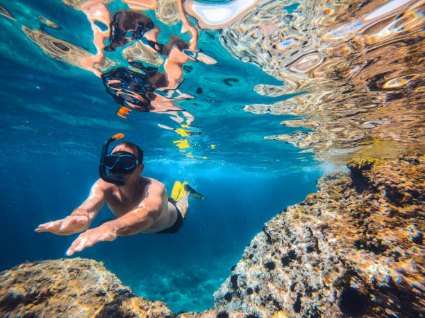 istock Men snorkeling by the reef 1193964263
