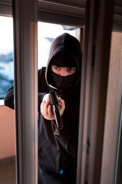 istock Burglar Breaking Into House 1193965514