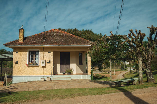 Old charming house in a traditional rural style Bento Gonçalves, Brazil - July 12, 2019. Facade of old charming working-class house near Bento Gonçalves. A country town famous for its wine production. brick wall paint brick common stock pictures, royalty-free photos & images