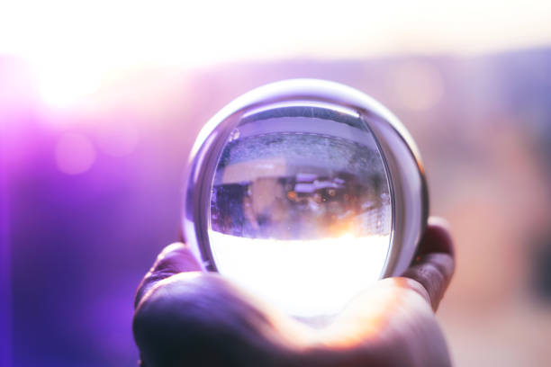 istock Glass ball on hand on mistery background 1193967758