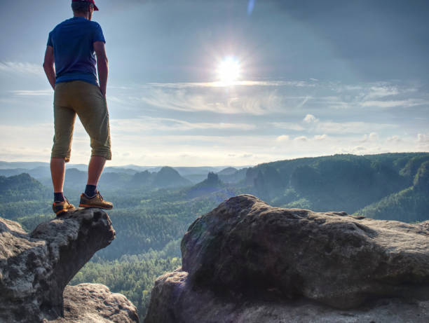 istock Handsome male athlete posing on rocks. Beautiful early spring 1193967826