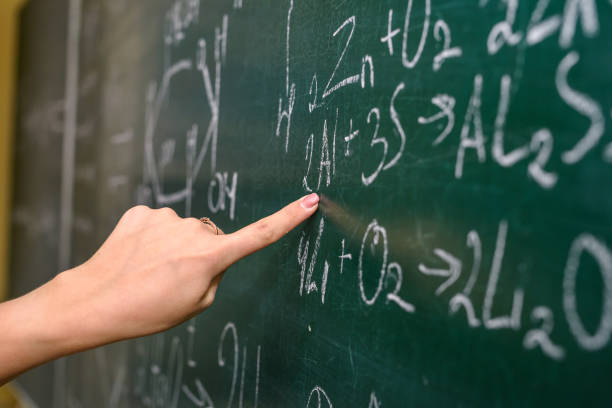 istock Female hand pointing at chemical formula on blackboard close up 1193968697