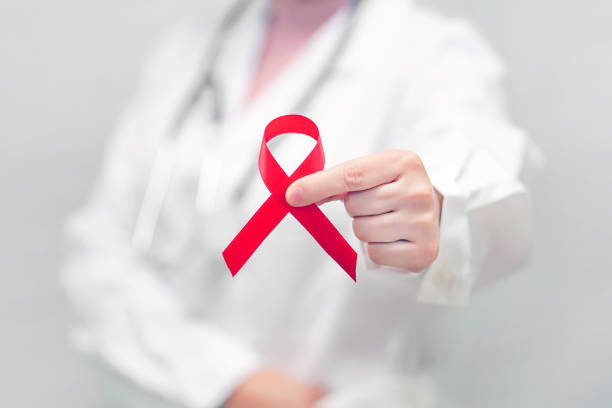 istock Doctor holding red ribbon. AIDS, HIV 1193969456
