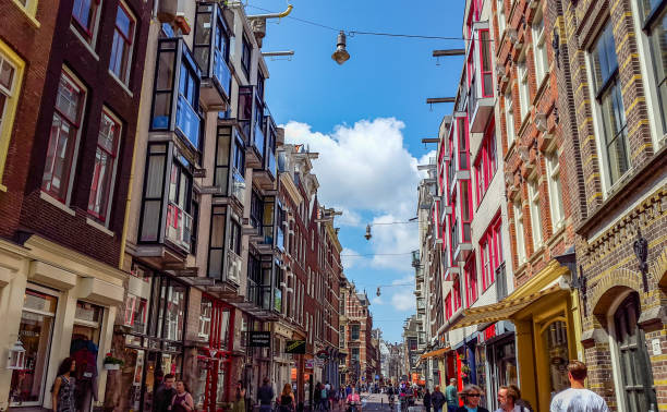 In June 2015, tourists and locals were enjoying Amsterdam's street on a sunny day