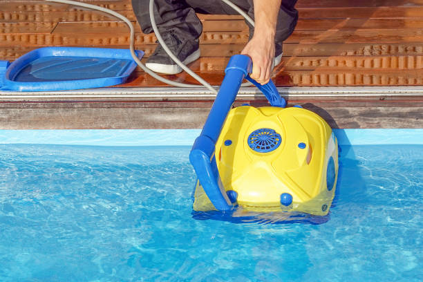 istock Hotel staff worker cleaning the pool 1193969699