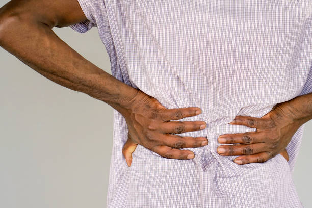istock African man, pain at lower back. 1193969846