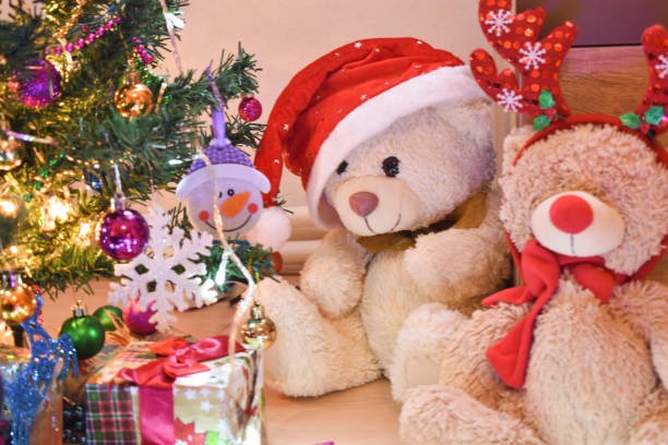 istock Two teddy bears next to a Christmas tree 1193970834