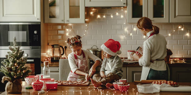 mère de famille heureuse et enfants font cuire des biscuits de noel - rolling dough pastry apron photos et images de collection