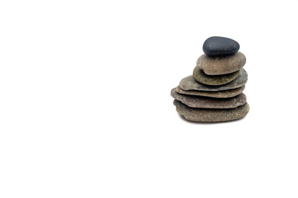 Stacked smooth grey stones. Sea pebble. Balancing pebbles isolated on white background