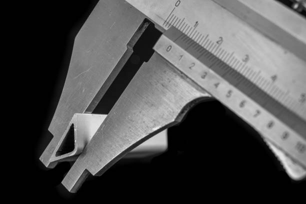 istock Caliper measurement in the workshop. Checking dimensions of made items. Dark background. 1193973017