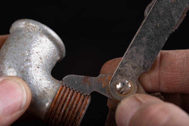istock Checking the screw thread with an analog meter. Correctness of the threaded connection. Dark background. 1193973020