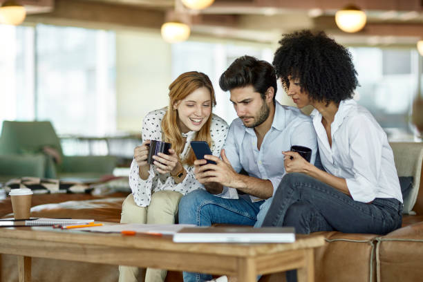 istock Young Businesspeople Checking Smart Phone During Break 1193973186