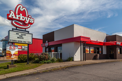 Niagara Falls, Canada - September 18, 2019: Arby's with blue sky in background in Niagara Falls, Canada. Arby's is an American quick-service fast-food sandwich restaurant chain