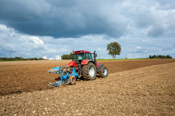 istock tractor is plowing the field in autumn 1193973993