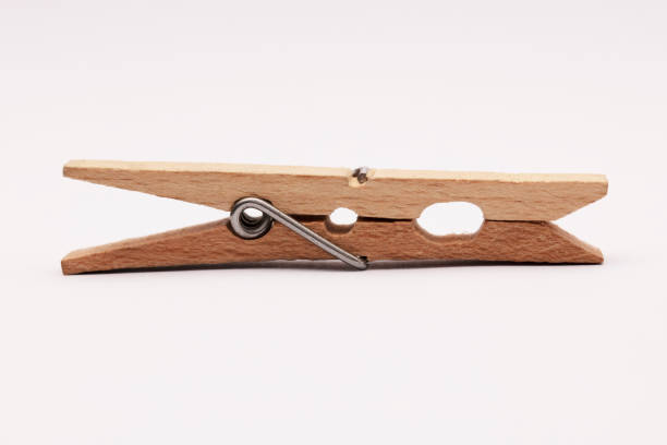 Wooden clothespin on the white background