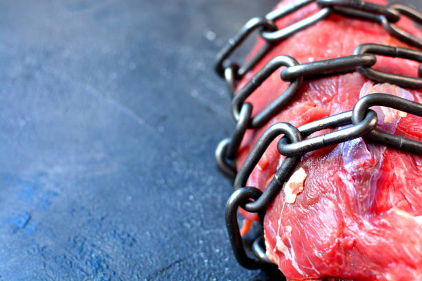 istock No meat background. Fresh meat coiled with chain. No animals products idea. 1193981583