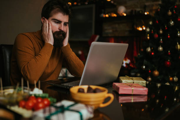 istock Worried man using laptop and working for Christmas 1193982477
