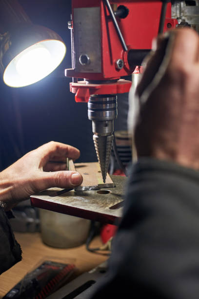 istock Hands of a man who drills a metal part on a machine tool. 1193983637