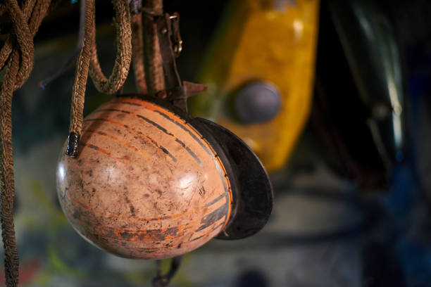 istock An old vintage scratched helmet hangs in a garage. 1193984227
