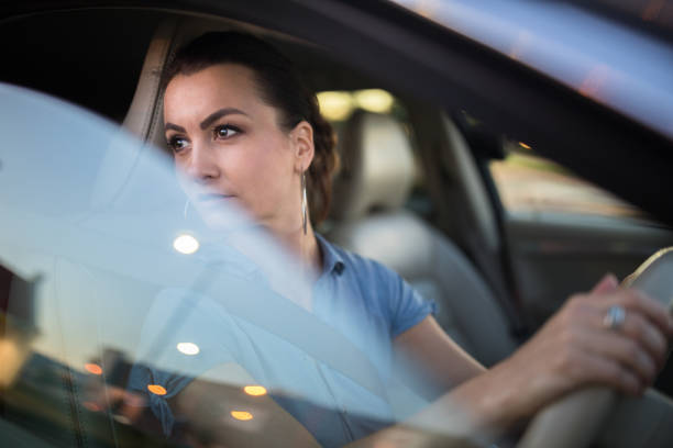 istock Pretty, young woman  driving a car 1193985062