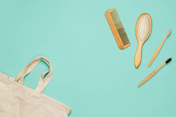 istock A canvas bag, wooden combs and bamboo toothbrushes on a mint background. Environmental concept 1193986817