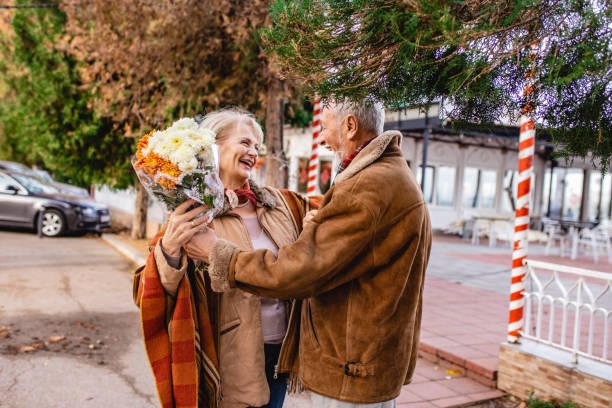 istock Senior man gives flowers 1193986955