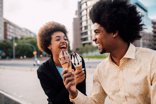 istock Young heterosexual couple eating ice cream and having fun 1193990455