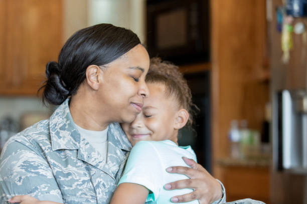 istock American hero mother embracing elementary age daughter 1193990483