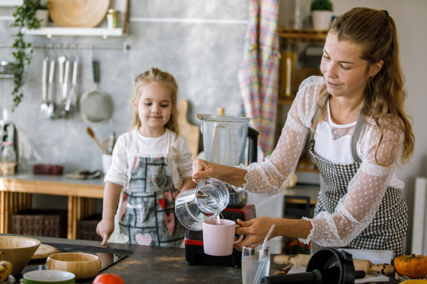 istock Mother making desserts with her toddler daughter 1193990795
