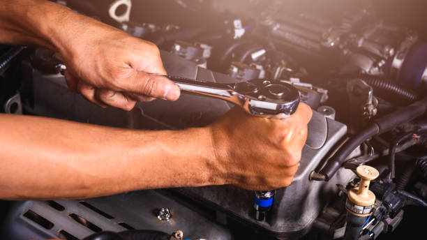 istock Hand of auto mechanic technician service engine and using wrench socket repairing car 1193996168