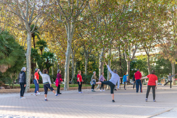 People meet to do exercises together in the park and plaza at the Templo de Debod in Madrid Madrid / Spain - October 16, 2019: People meet to do exercises together in the park and plaza at the Templo de Debod (Temple of Debod), a famous tourist attraction in central Madrid. woman legs open stock pictures, royalty-free photos & images