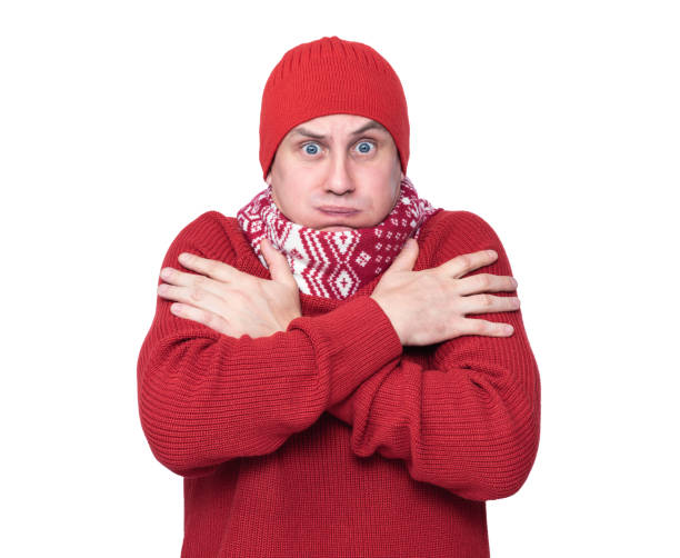 Frozen man in a red sweater and hat, isolated on white background. File contains a path to isolation.
