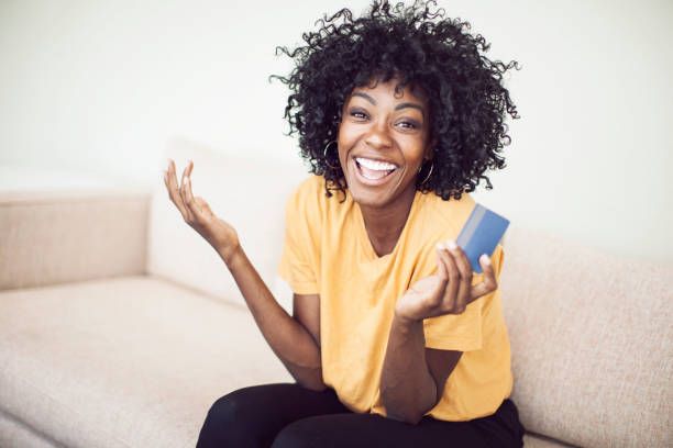 Happy adult woman shopping online at home stock photo