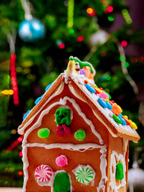 istock Gingerbread house with peppermint candies and christmas tree. 1194016431