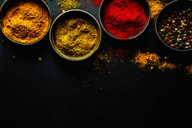 istock Colorful spices on dark background 1194016636