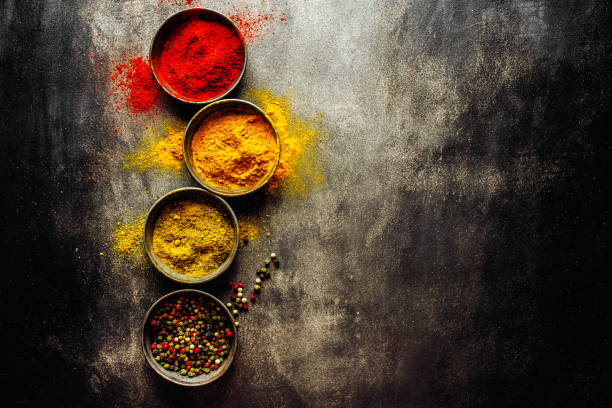 istock Colorful spices on dark background 1194016783