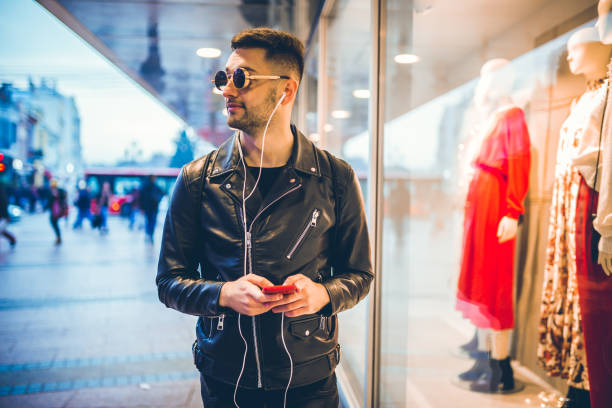 istock Young man walking down the city Streets 1194019027