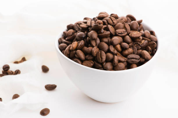 istock Bowl of caffee beans on a white background 1194019968