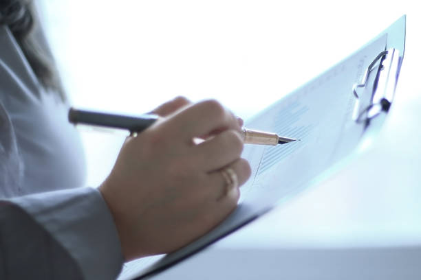 istock close up. business woman checking financial data. 1194019987